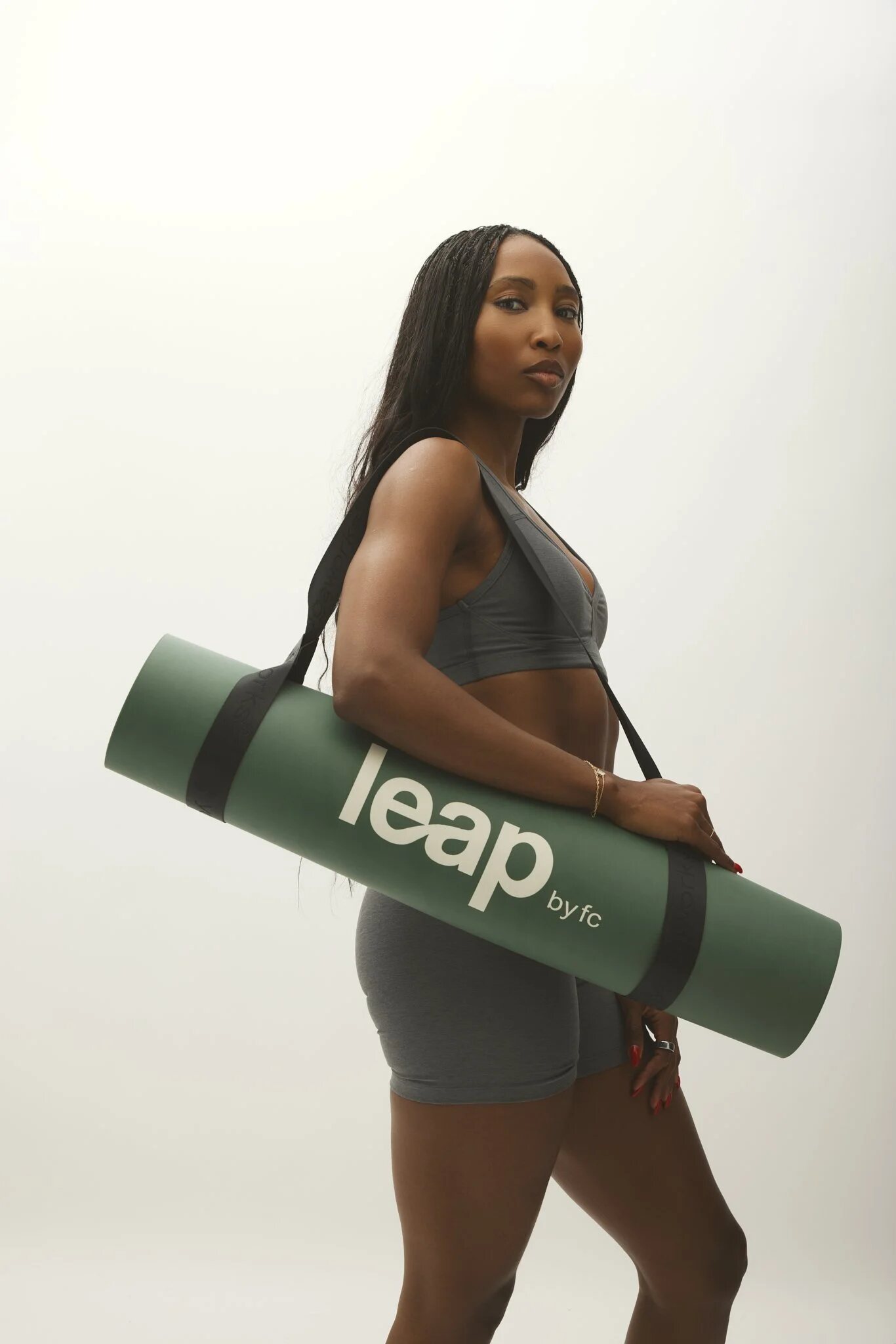 Francia Cooper carrying the rolled green Leap mat